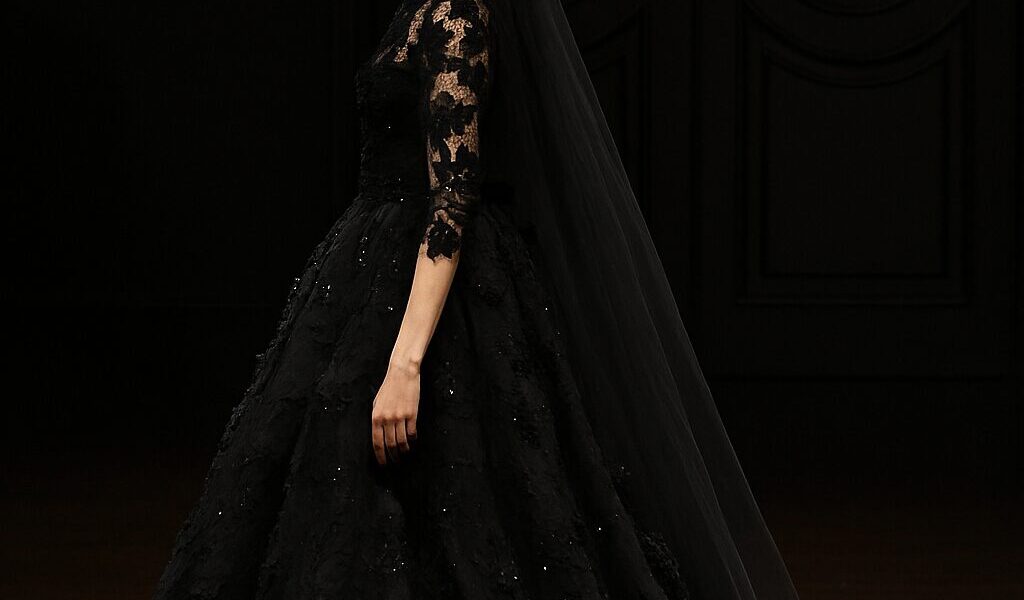 Bride wearing a stunning black wedding dress, styled with elegant accessories for a unique and modern bridal look.