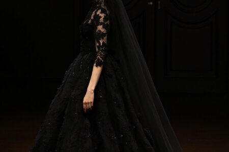 Bride wearing a stunning black wedding dress, styled with elegant accessories for a unique and modern bridal look.